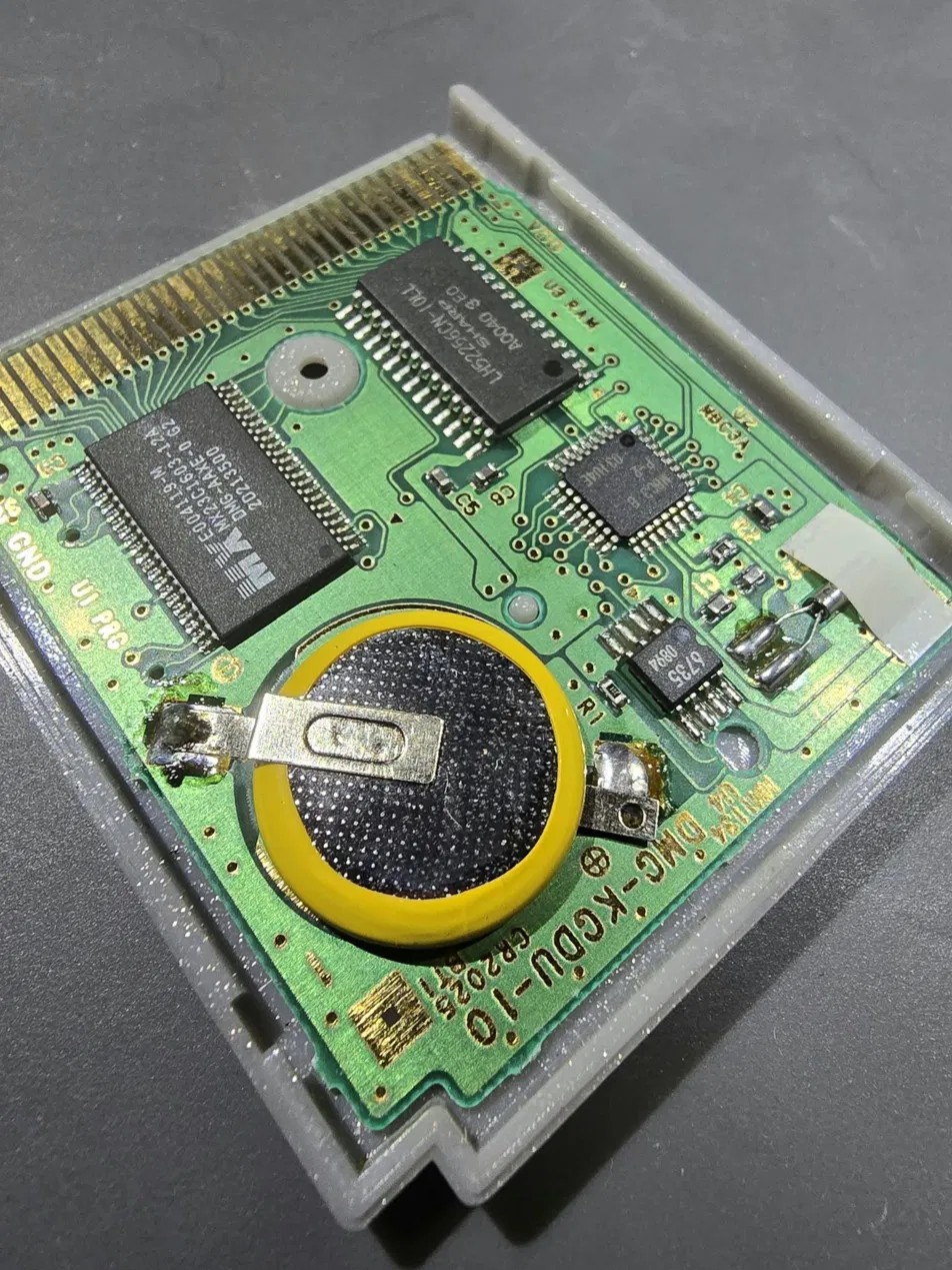 Old worn save battery on Game Boy cartridge board