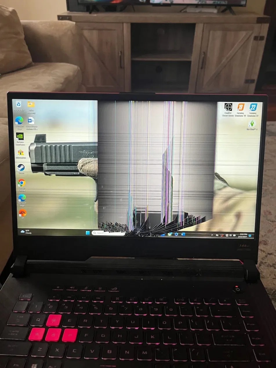 ASUS ROG laptop with cracked, striped screen